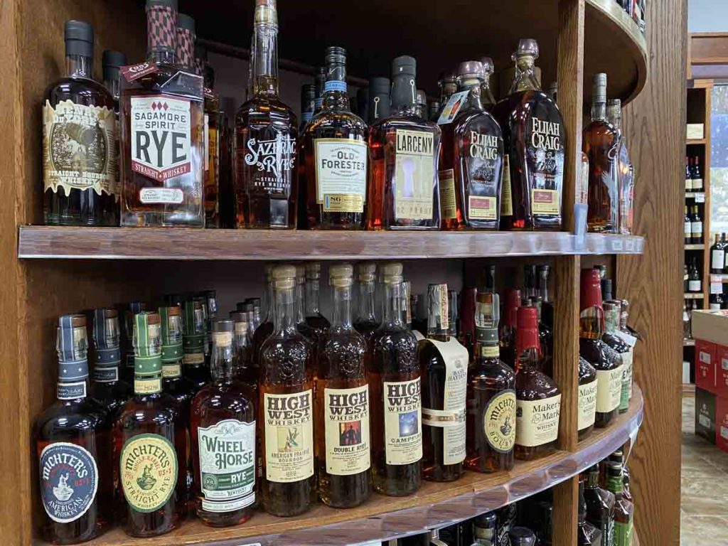 Shelves of various whiskeys and bourbons